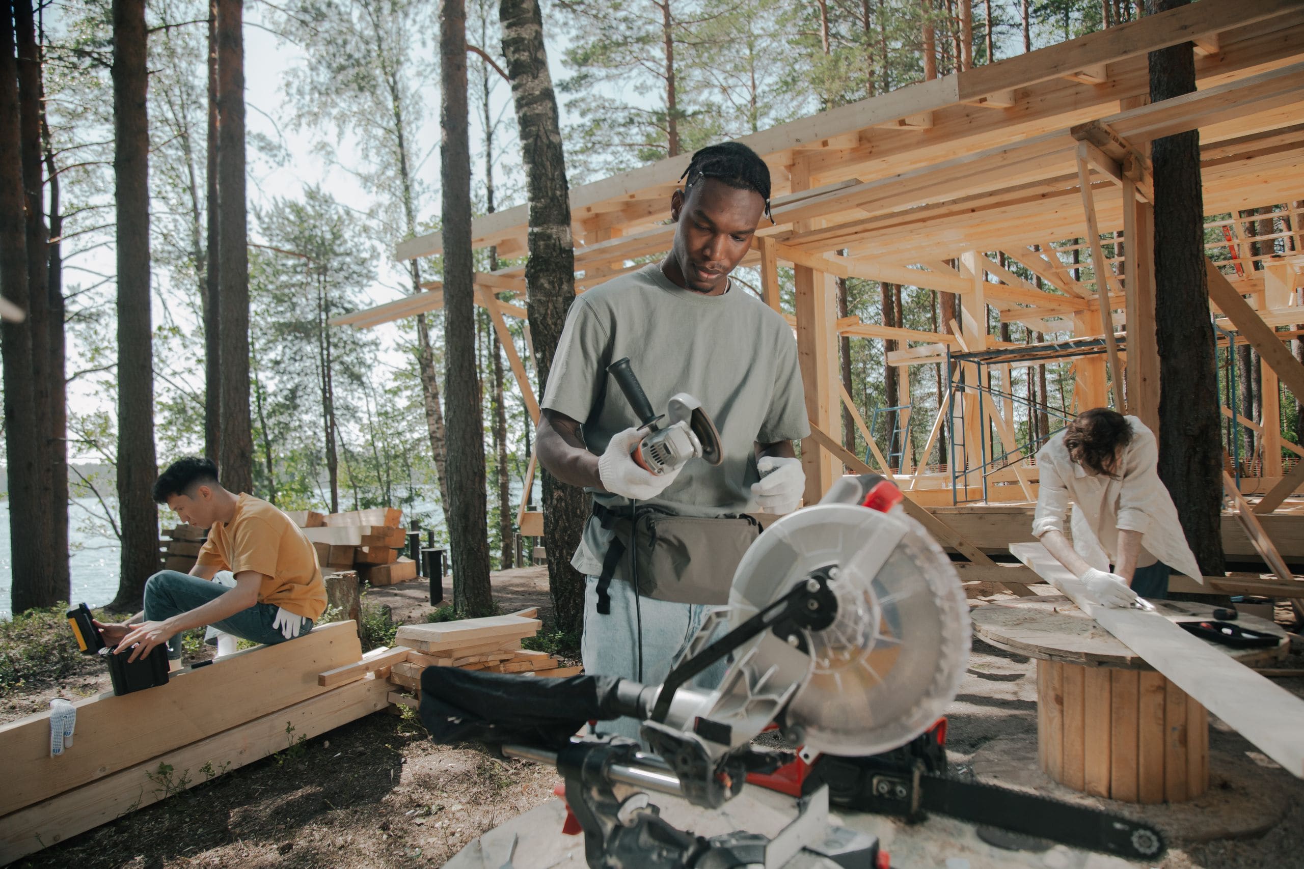Crew raising a timber frame structure on an active build site
